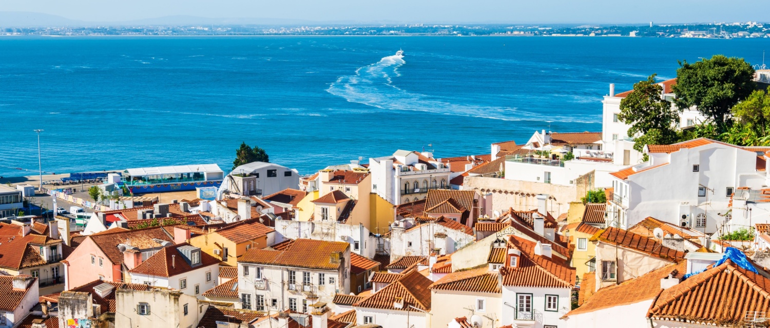 View of Lisbon old town Alfama district with houses clay orange roofs from viewpoint Portas do Sol, Lisbon, Portugal