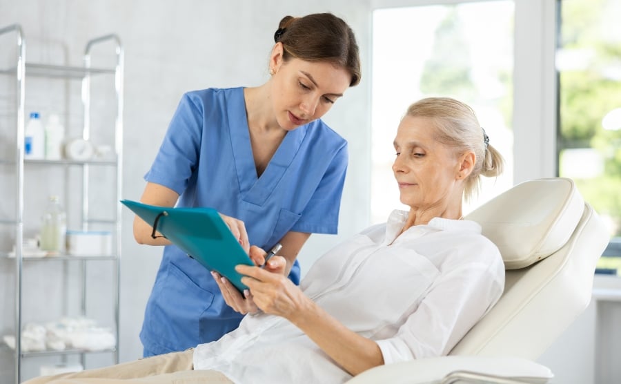 Woman signing a form in hospital